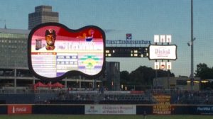 The guitar-shaped scoreboard/video board and guitar-pick shaped signage honor "Music City."